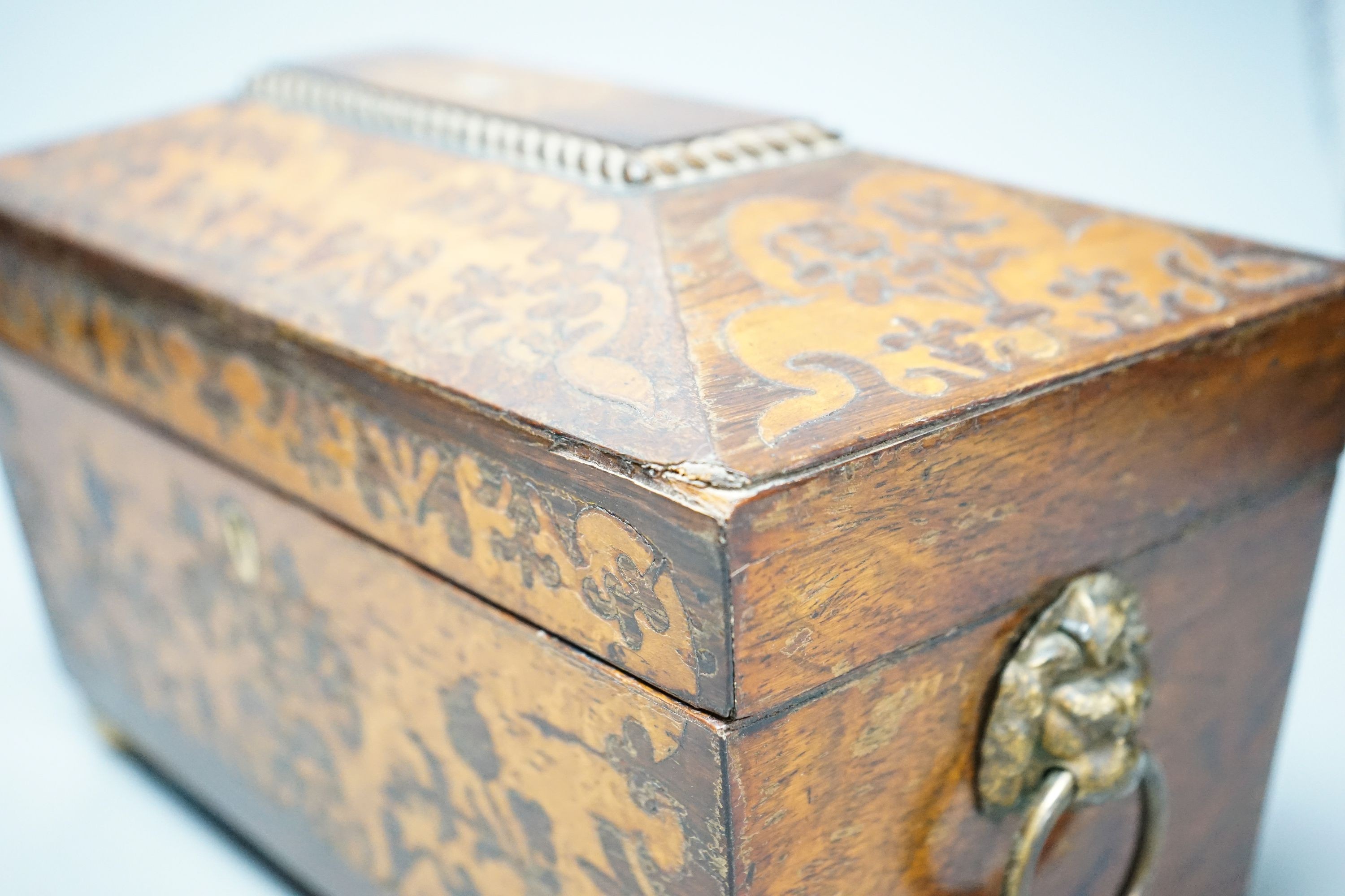 A 19th century rosewood and bird’s eye maple tea caddy, of sarcophagus form, the interior with mixing bowl, on ball feet 31cm